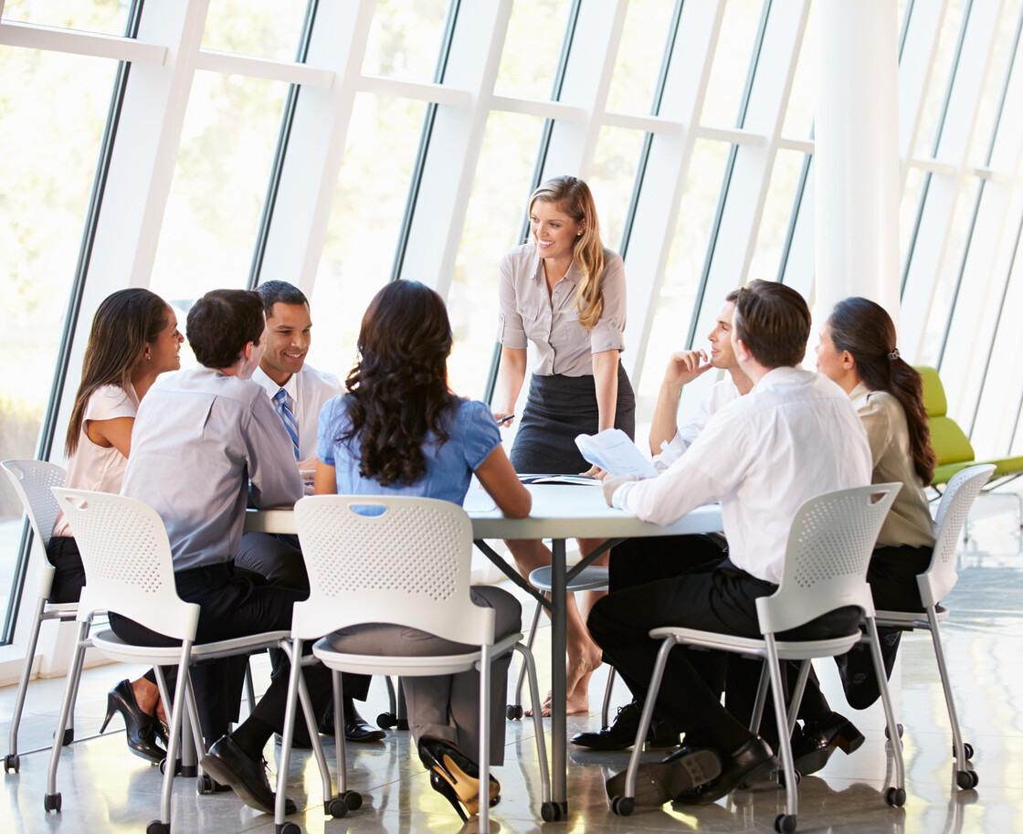 Emerging Professionals collaborate in a bright, modern office during a productive business meeting.