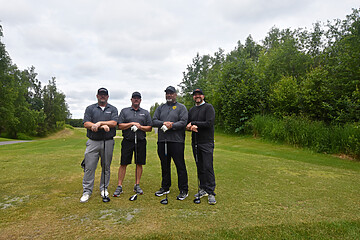 Friends enjoying a day of golf on the course, showcasing camaraderie and sportiness.
