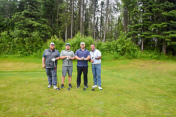 Golfing friends enjoying a sunny day at a beautiful golf course.