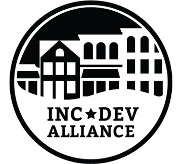 Circular logo of INC★DEV ALLIANCE, featuring abstract architectural designs symbolizing community and collaboration.